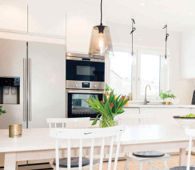 Modern white family kitchen with stainless steel appliances